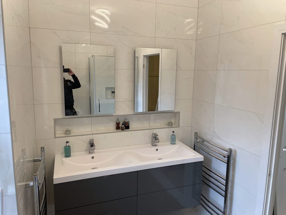 Bathroom plumbing fit-out with double basin unit and heated towel rail