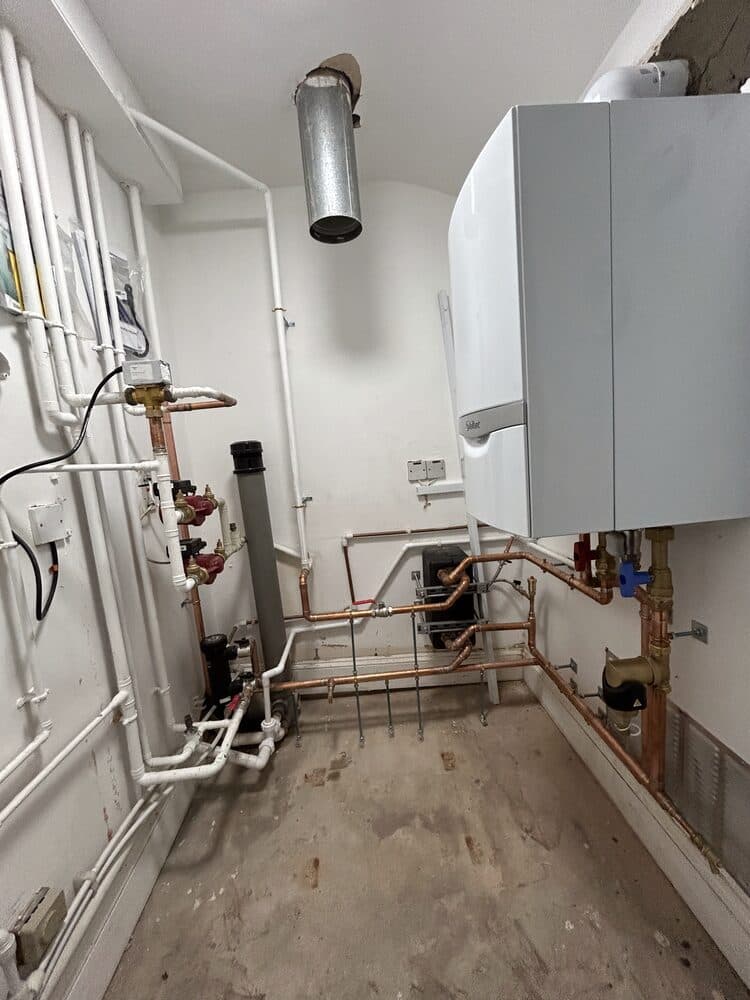 Boiler and hot water cylinder installed together in an airing cupboard