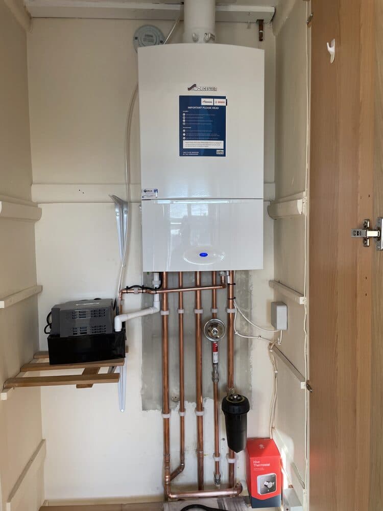 Boiler neatly installed in a wooden cupboard surround