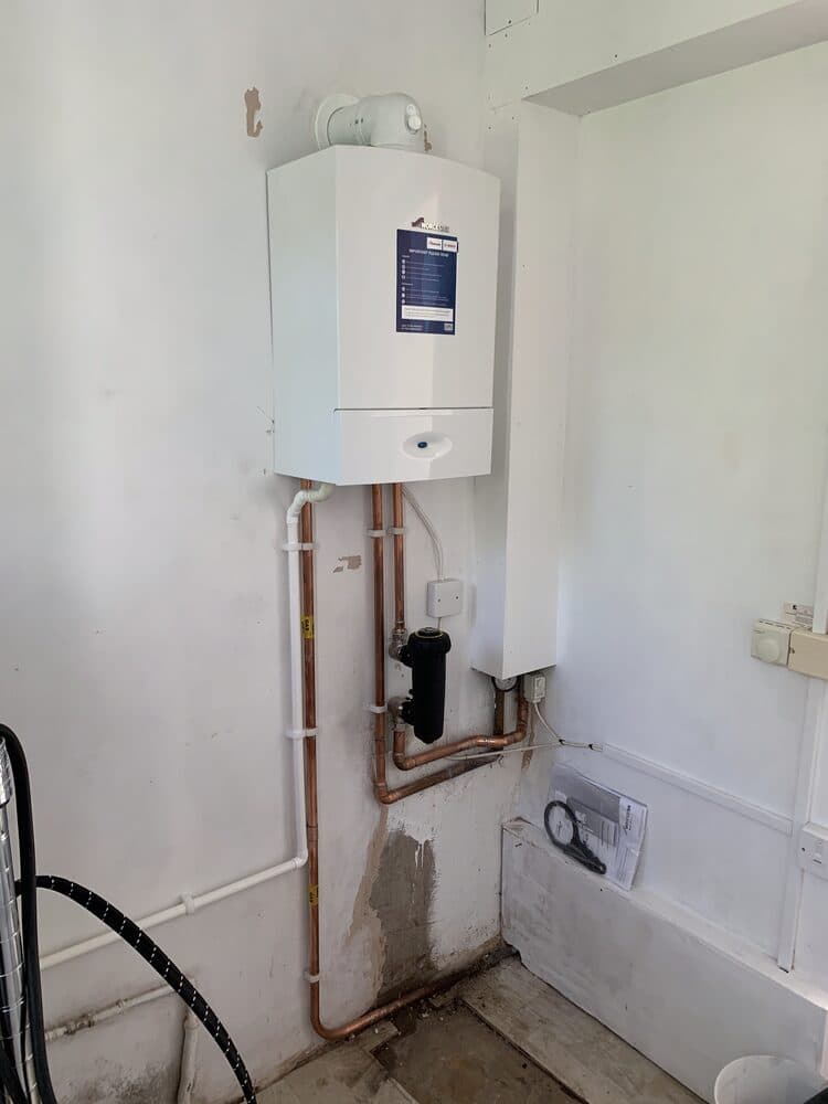 Compact boiler installed in a bathroom utility space