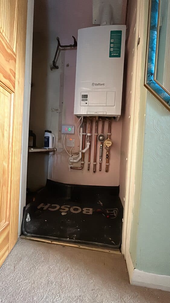 Newly installed combi boiler fitted in an airing cupboard