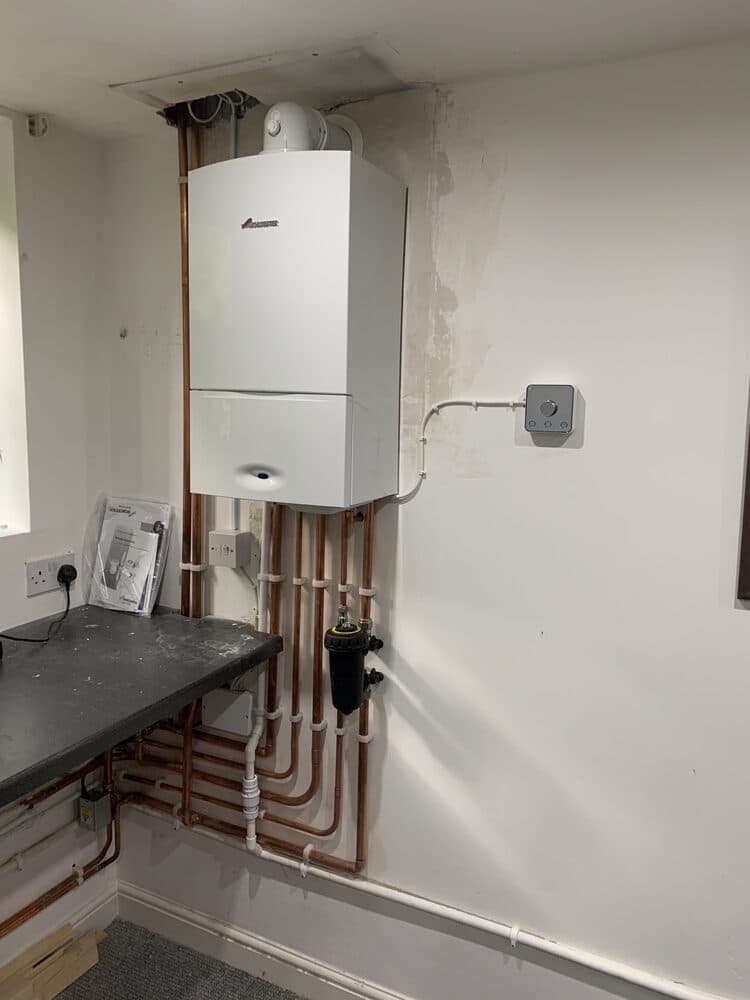 Boiler installed above a kitchen worktop with tidy pipework