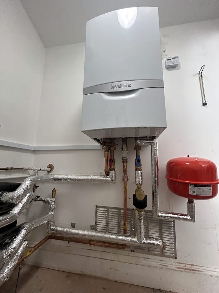 Vaillant boiler installed with red expansion vessel and neat pipework