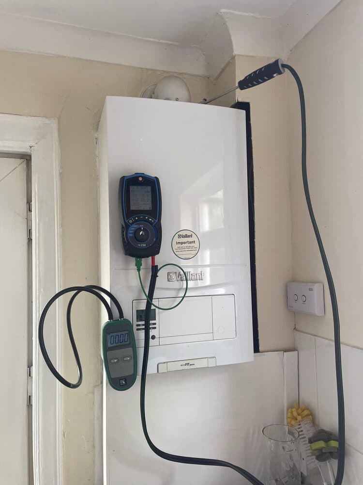 Combustion analyser connected to a boiler during a service visit